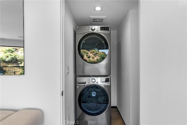 laundry room featuring laundry area and stacked washing maching and dryer