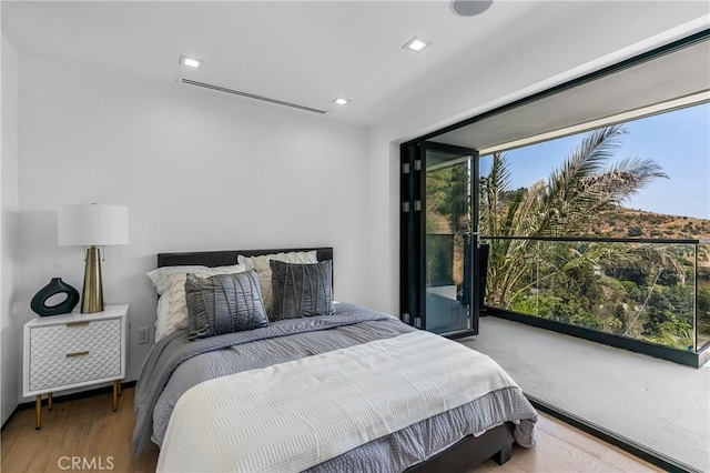 bedroom featuring recessed lighting and wood finished floors