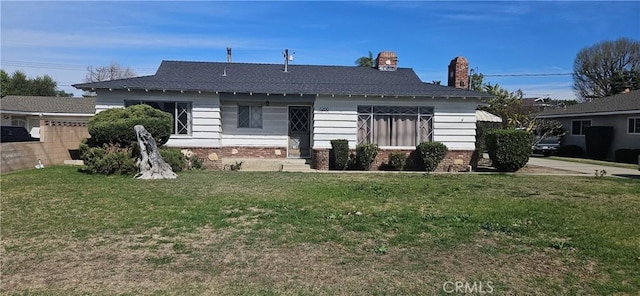 bungalow-style house with a front lawn