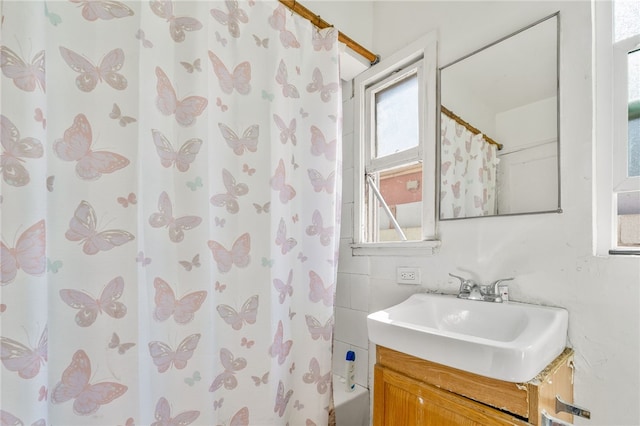 full bathroom featuring vanity and shower / bath combo with shower curtain