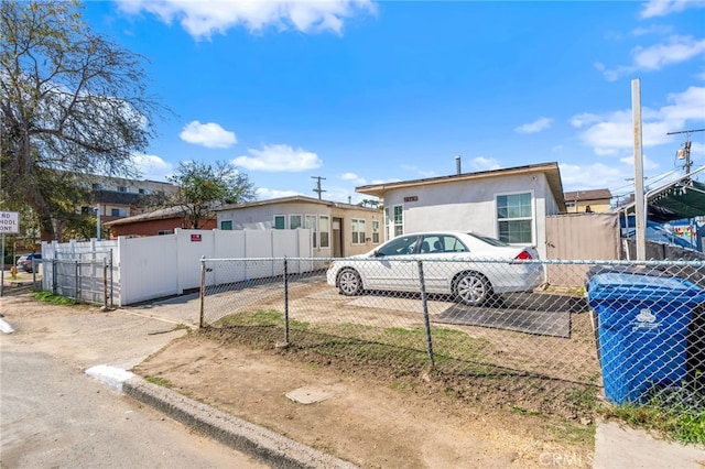 manufactured / mobile home with a fenced front yard and stucco siding