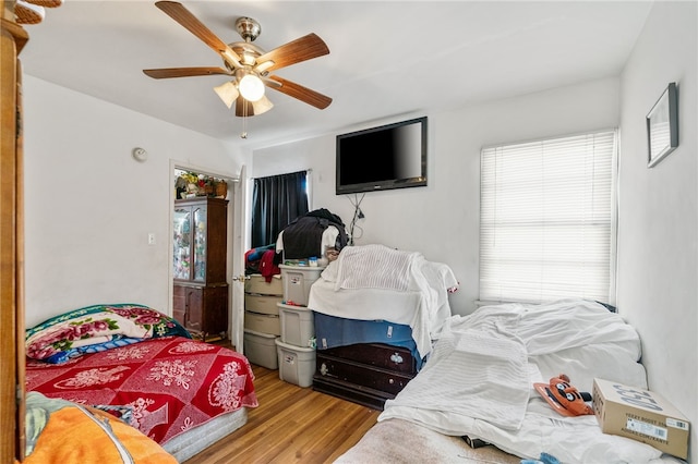 bedroom with ceiling fan and wood finished floors