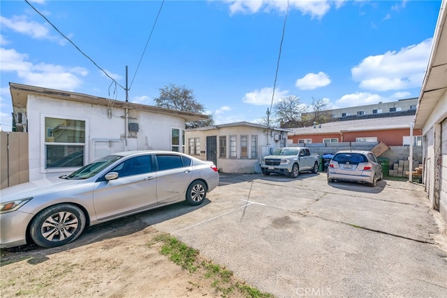 view of front of home featuring uncovered parking and fence