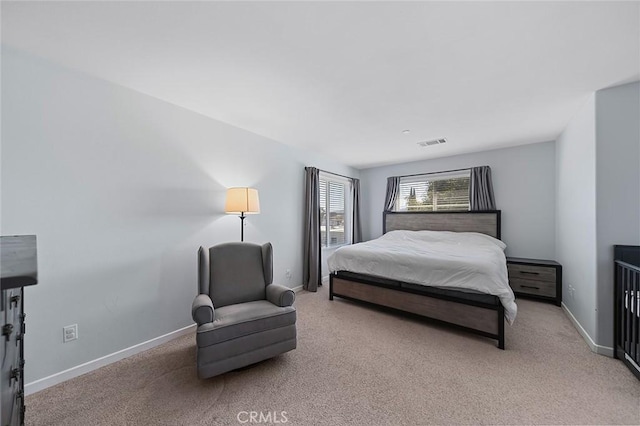 carpeted bedroom with visible vents and baseboards