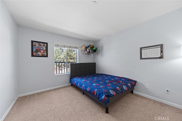 bedroom featuring carpet and baseboards