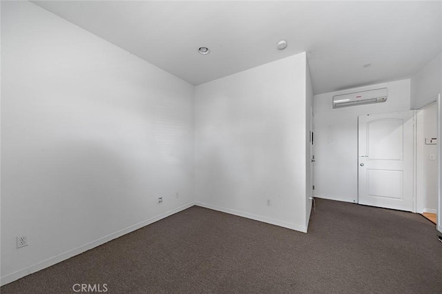 unfurnished room with baseboards, carpet floors, and an AC wall unit