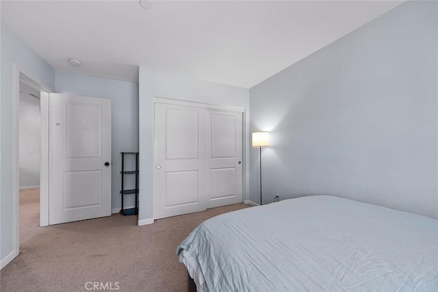 bedroom featuring a closet and carpet flooring