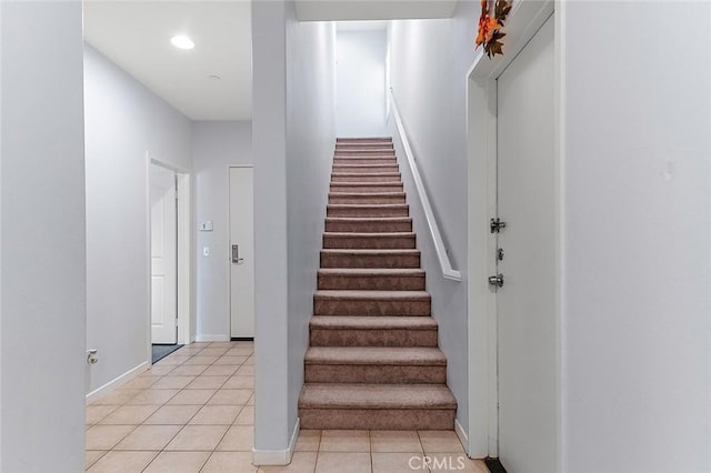 staircase with tile patterned flooring, recessed lighting, and baseboards