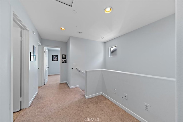 hallway featuring recessed lighting, an upstairs landing, baseboards, and carpet floors