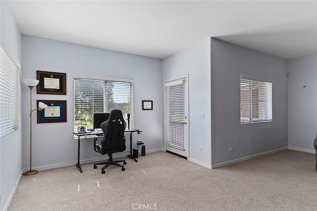 carpeted office space featuring baseboards