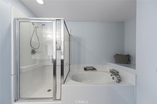 full bathroom featuring a garden tub and a shower stall