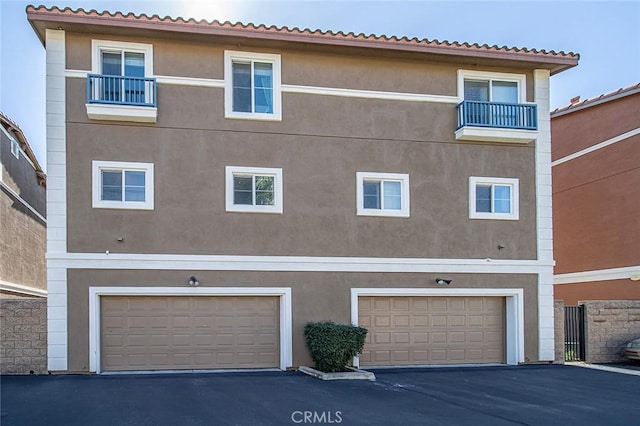 exterior space with stucco siding and a garage