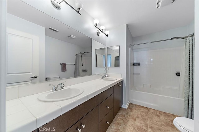 bathroom featuring a sink, visible vents, and toilet