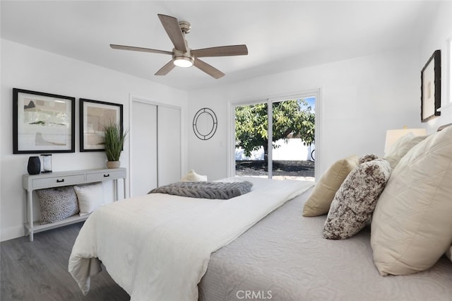 bedroom featuring a ceiling fan, wood finished floors, baseboards, a closet, and access to outside