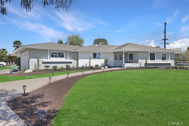 single story home featuring an attached garage and a front lawn