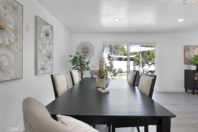 dining space featuring recessed lighting, baseboards, and wood finished floors