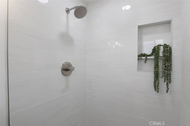 bathroom with tiled shower