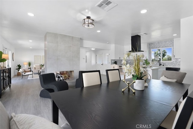 dining space with light wood-style flooring, recessed lighting, and visible vents