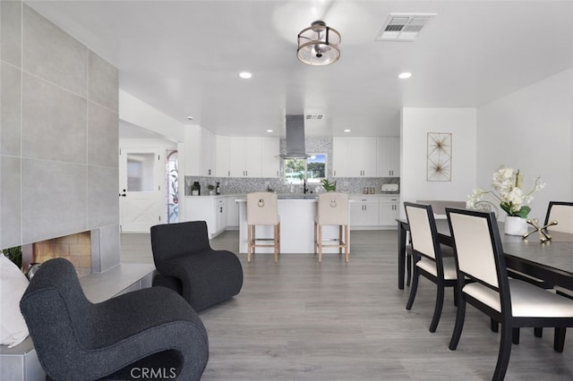 dining space with recessed lighting, visible vents, and light wood-style flooring