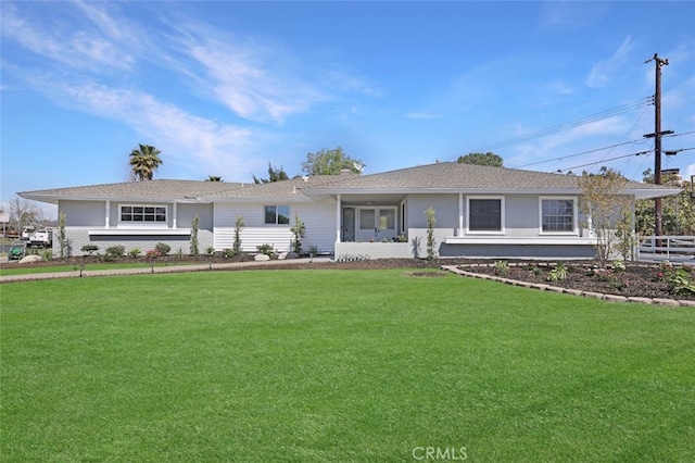 ranch-style home with a front lawn