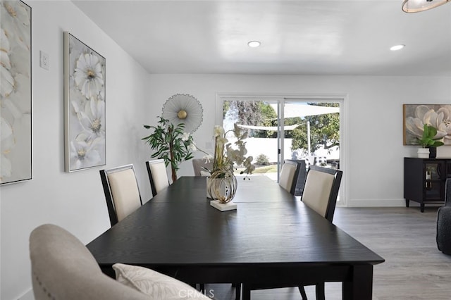 dining area featuring recessed lighting, baseboards, and wood finished floors