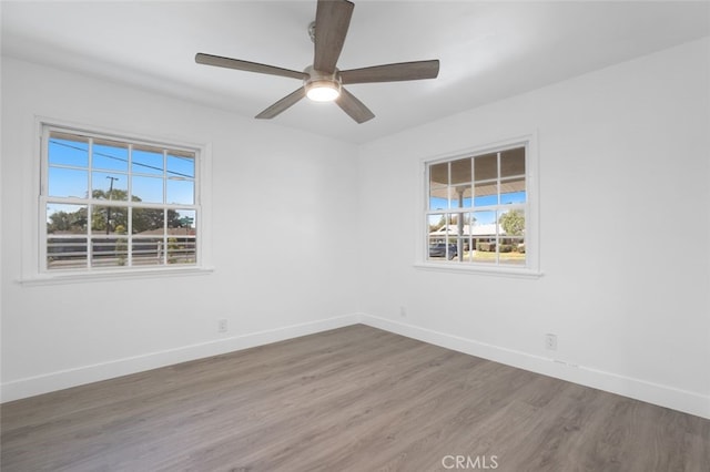 unfurnished room with ceiling fan, baseboards, and wood finished floors