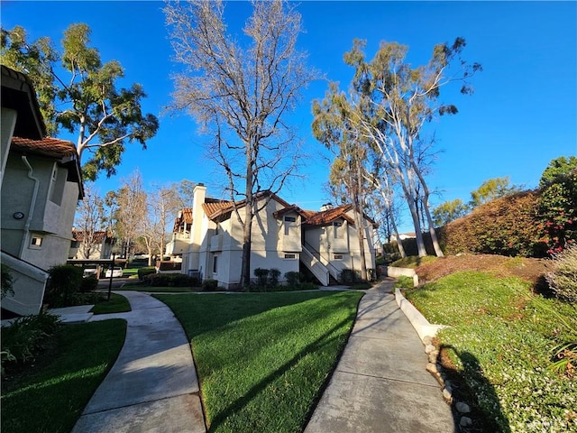 view of property exterior with a yard and a chimney