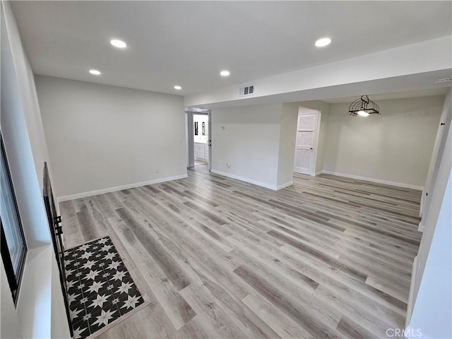 spare room with light wood-style flooring, recessed lighting, visible vents, and baseboards