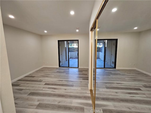 spare room with recessed lighting and wood finished floors