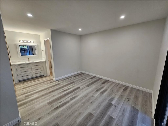 unfurnished bedroom featuring recessed lighting, baseboards, and light wood finished floors