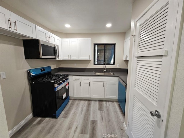 kitchen featuring dishwashing machine, dark countertops, gas stove, a sink, and stainless steel microwave