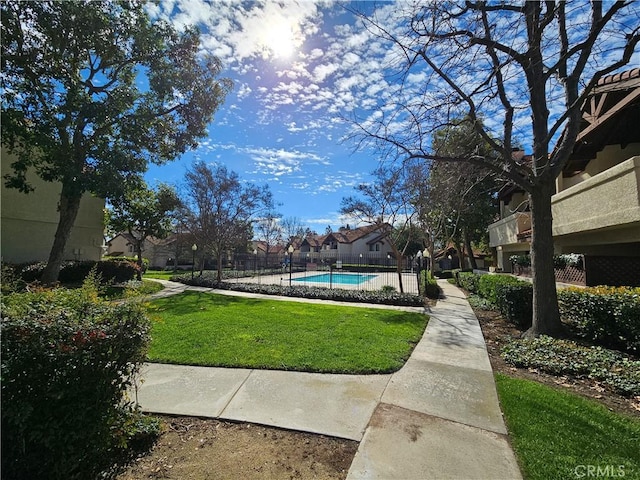 view of yard featuring a fenced in pool and fence