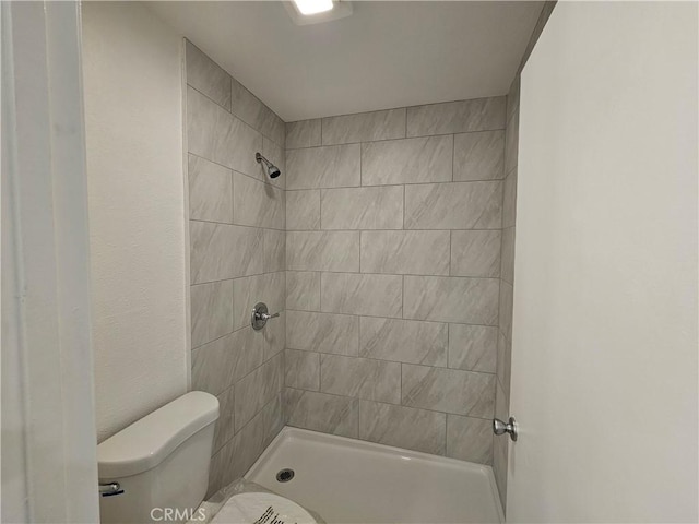 full bathroom with toilet and tiled shower