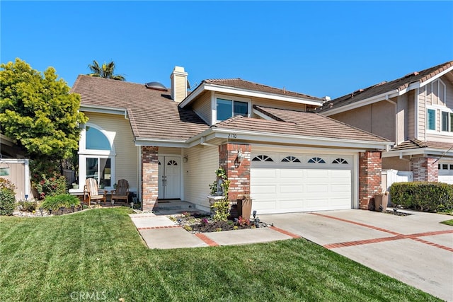 2170 Via Teca Unit 63, San Clemente, CA 92673 - traditional home featuring brick siding, a front yard, concrete driveway, a chimney, and a garage
