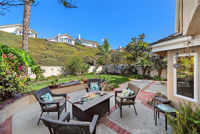 view of patio / terrace featuring an outdoor living space with a fire pit and a fenced backyard