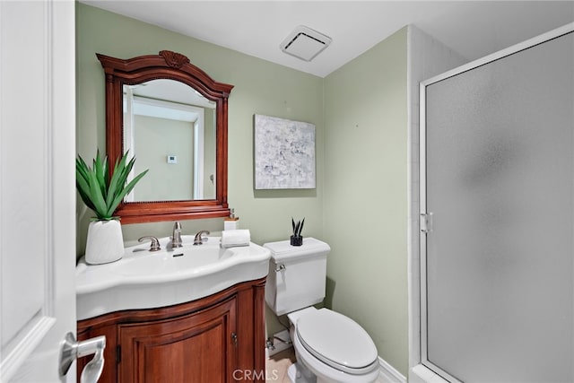 bathroom featuring visible vents, a stall shower, toilet, and vanity