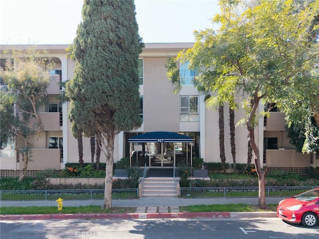 view of building exterior featuring fence