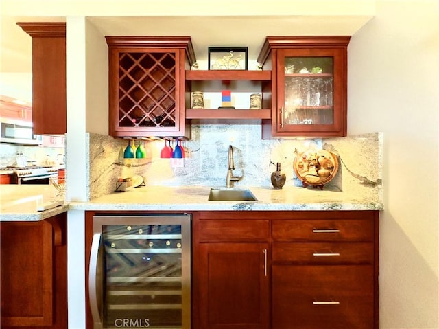 bar with wine cooler, backsplash, indoor wet bar, and a sink