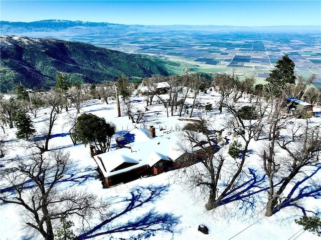 snowy aerial view featuring a mountain view