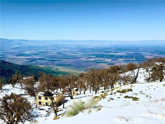 snowy aerial view featuring a mountain view