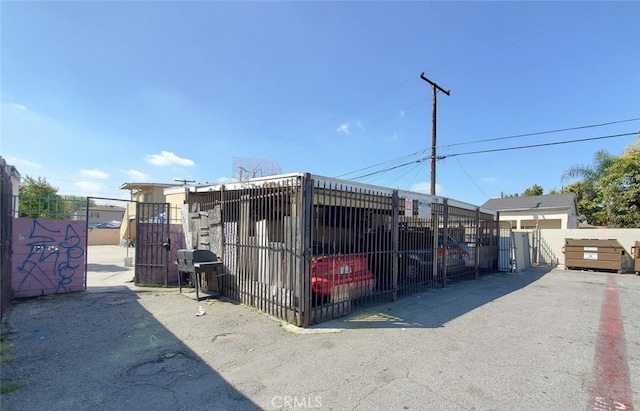 view of outbuilding with a gate and fence