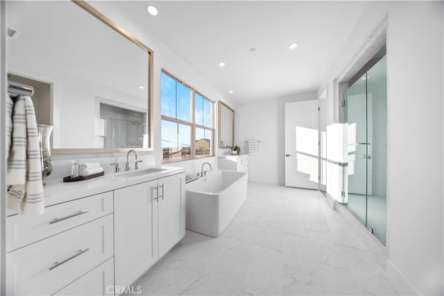 bathroom featuring a shower, marble finish floor, a freestanding tub, recessed lighting, and vanity