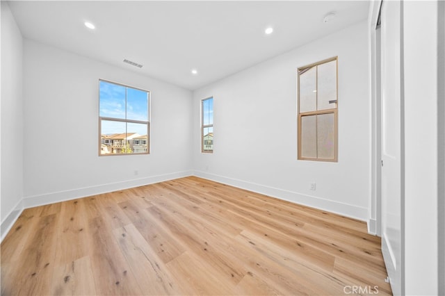 empty room featuring baseboards, recessed lighting, visible vents, and light wood-type flooring