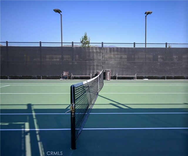 view of sport court featuring fence