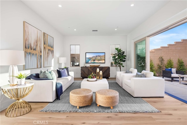 living room featuring visible vents, wood finished floors, and recessed lighting