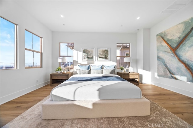 bedroom featuring recessed lighting, wood finished floors, and baseboards