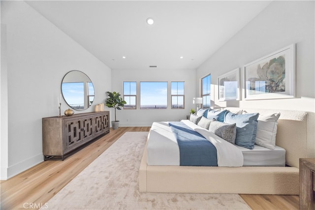 bedroom featuring baseboards, wood finished floors, and recessed lighting