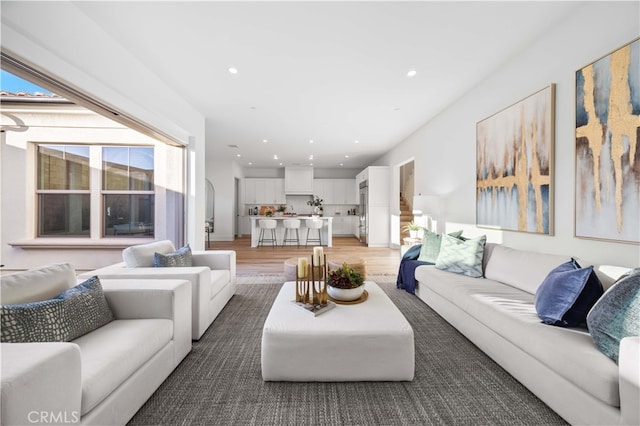 living room with light wood-style floors and recessed lighting