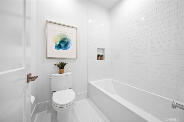 bathroom with baseboards, toilet, and tile patterned flooring