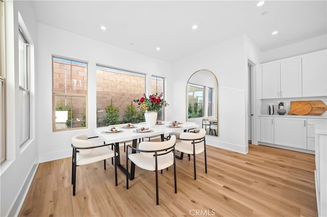 dining area with light wood-style flooring, baseboards, and recessed lighting
